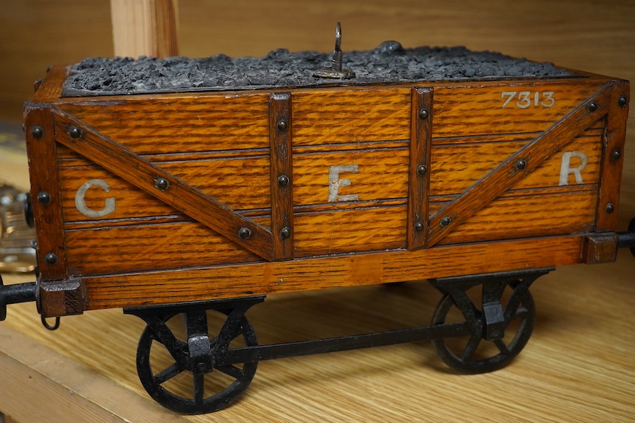 A late 19th or early 20th century novelty cigar box in the form of a railway coal wagon in Great Eastern Railway livery, of oak construction with sectioned interior, integrated match striker, and dummy coal load hiding t